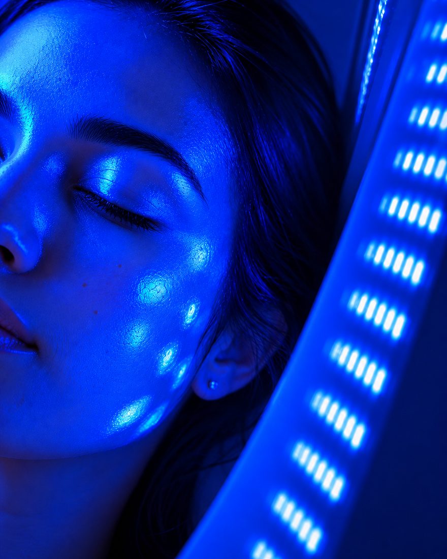Client relaxing under blue LED light therapy for acne at Neo Elegance Skin Clinic, Derby