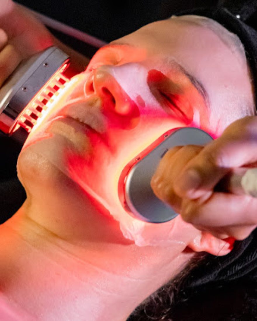 Client receiving an advanced facial treatment with red LED light at Neo Elegance Skin Clinic, Derby